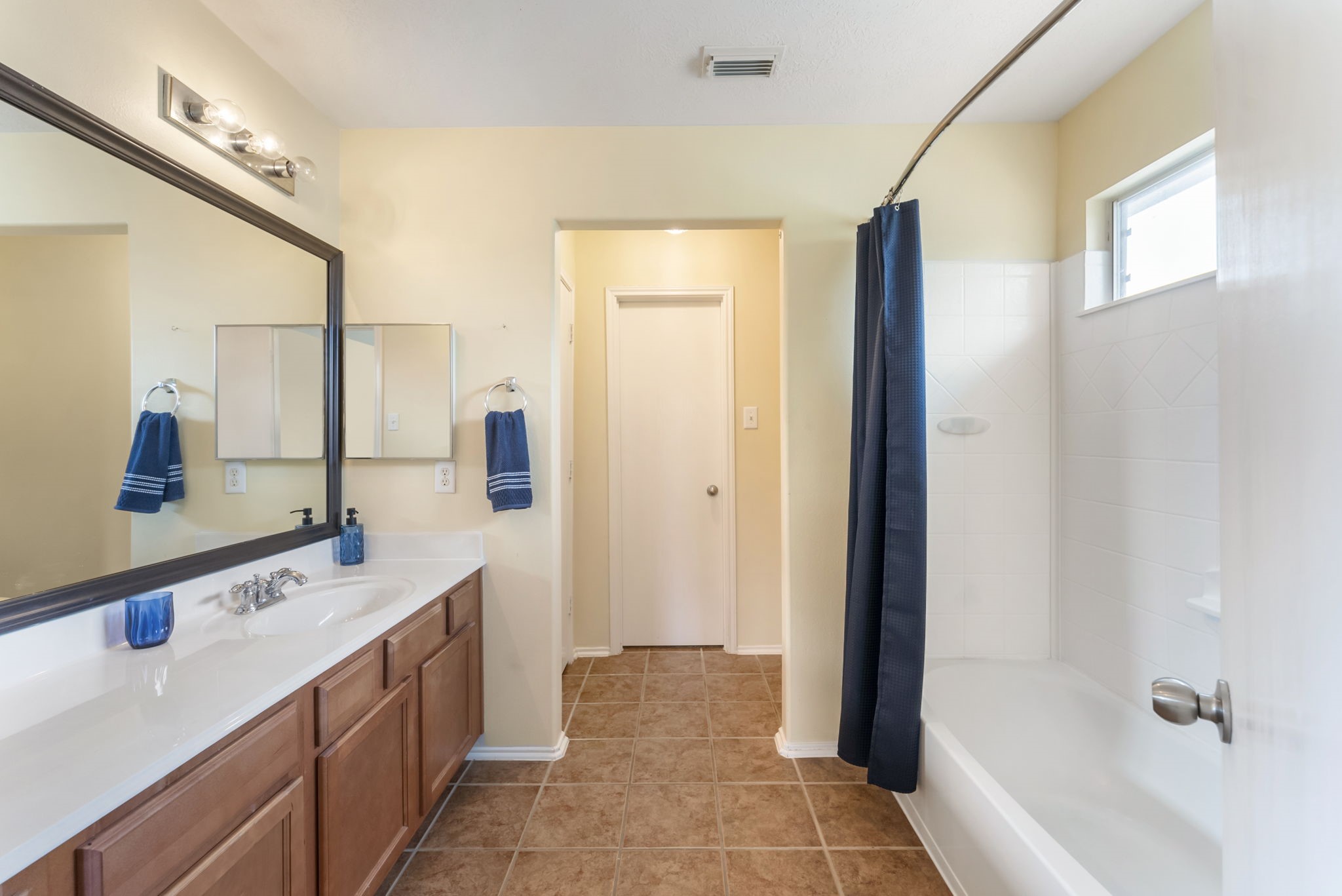 7203 Cool Springs Magnolia, TX 77354 - Photo 18 of 31 a bathroom with a double vanity sink a mirror and a bathtub