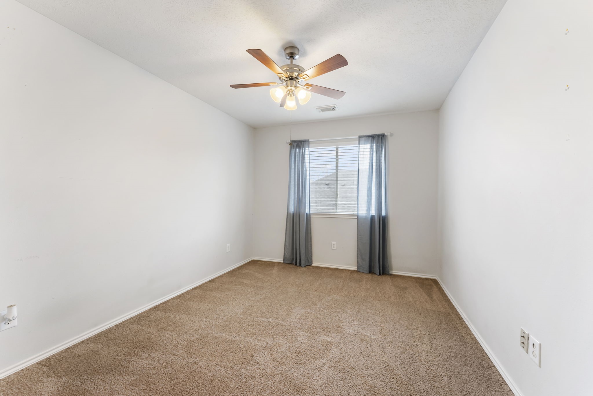 7203 Cool Springs Magnolia, TX 77354 - Photo 23 of 31 an empty room with window and ceiling fan