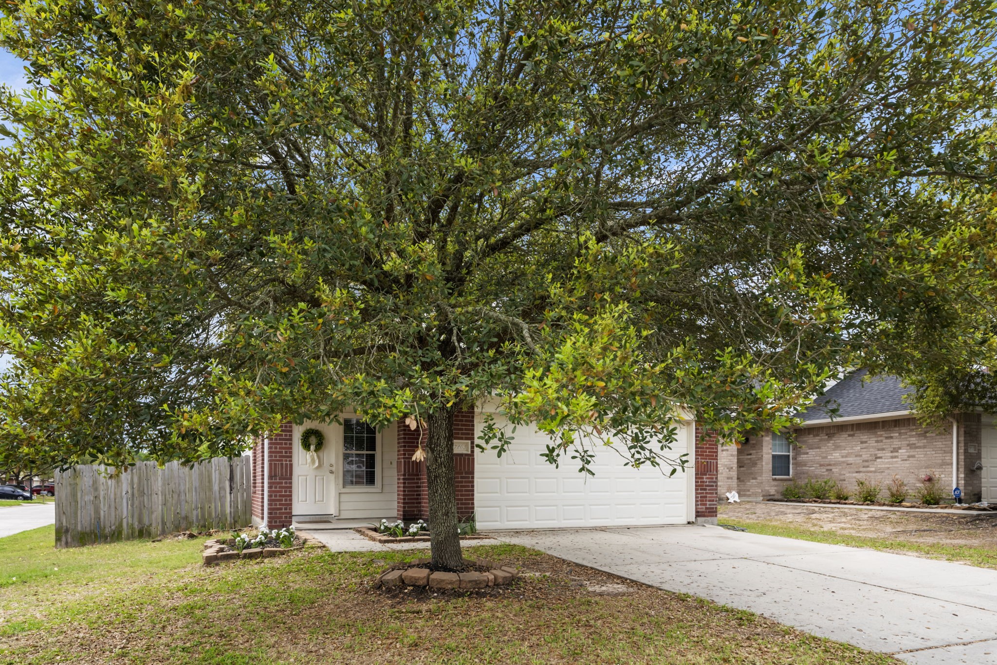 7203 Cool Springs Magnolia, TX 77354 - Photo 29 of 31 a front view of a house with a yard garage and large tree
