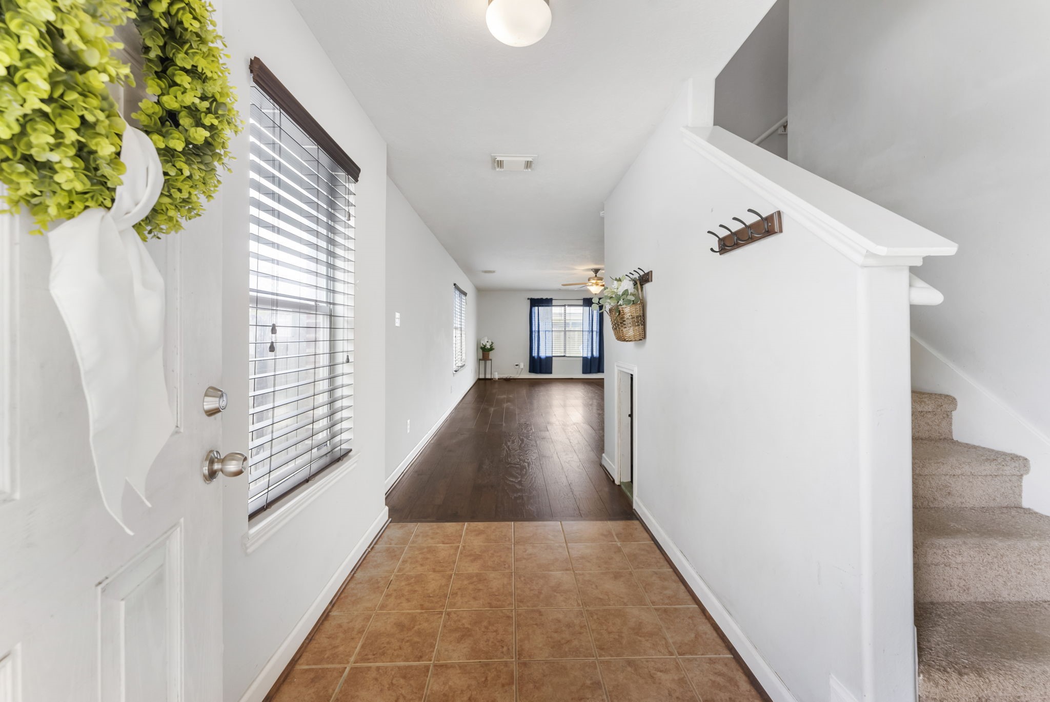 7203 Cool Springs Magnolia, TX 77354 - Photo 4 of 31 a view of a hallway with wooden floor and staircase