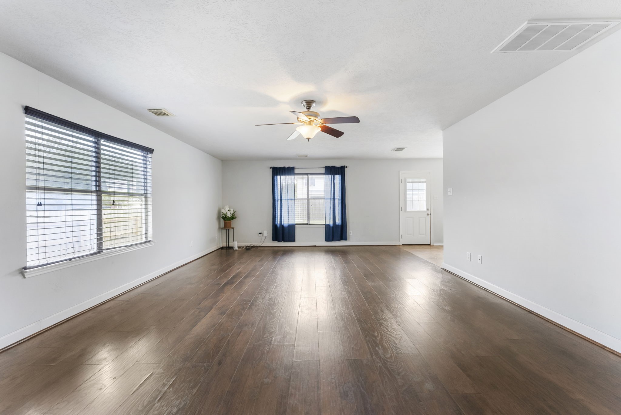 7203 Cool Springs Magnolia, TX 77354 - Photo 7 of 31 a view of an empty room with wooden floor and a window
