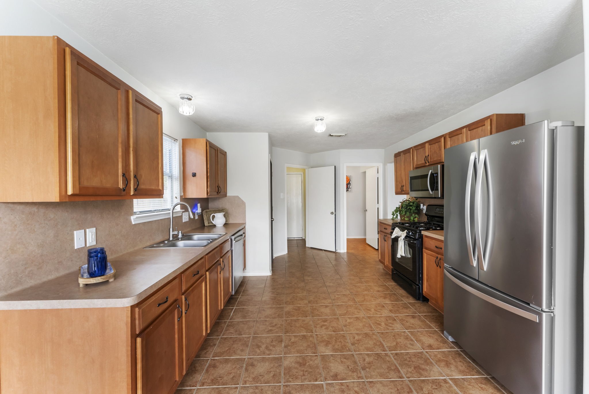 7203 Cool Springs Magnolia, TX 77354 - Photo 9 of 31 a kitchen with stainless steel appliances granite countertop a refrigerator and a sink