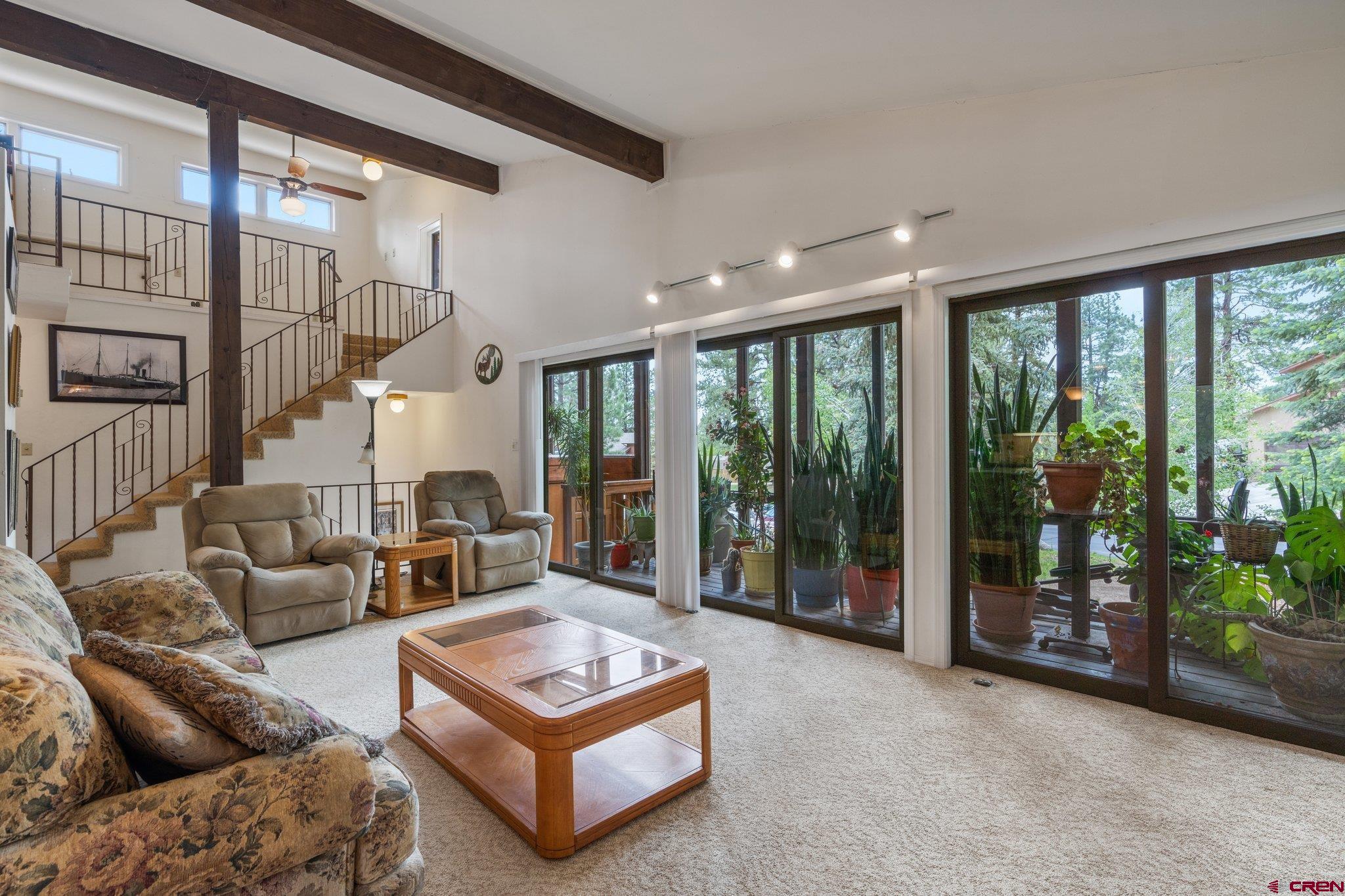 67 Pine Ridge Loop Durango, CO 81301 - Photo 11 of 35 a living room with furniture a ceiling fan and a large window