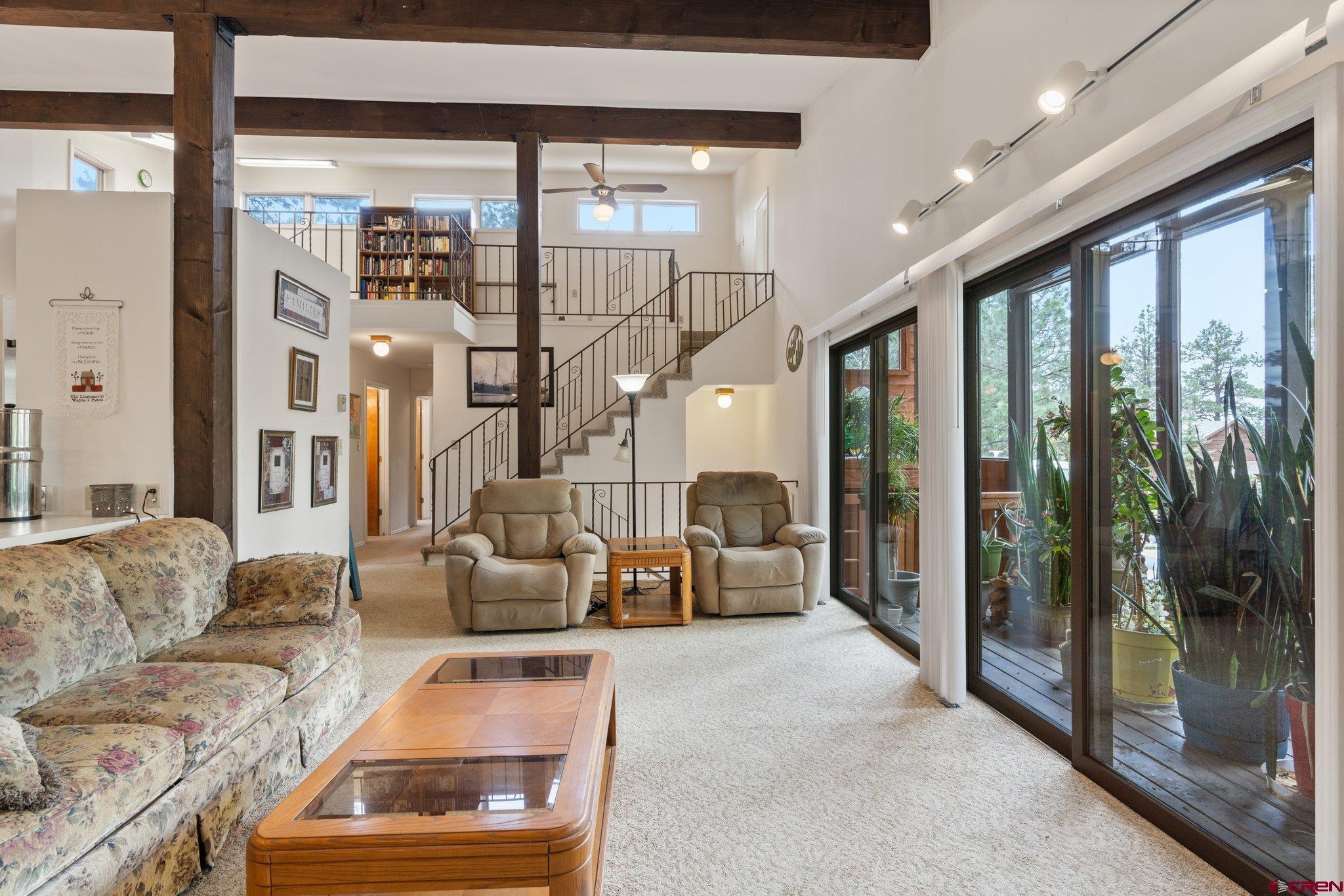 67 Pine Ridge Loop Durango, CO 81301 - Photo 13 of 35 a living room with furniture and a floor to ceiling window
