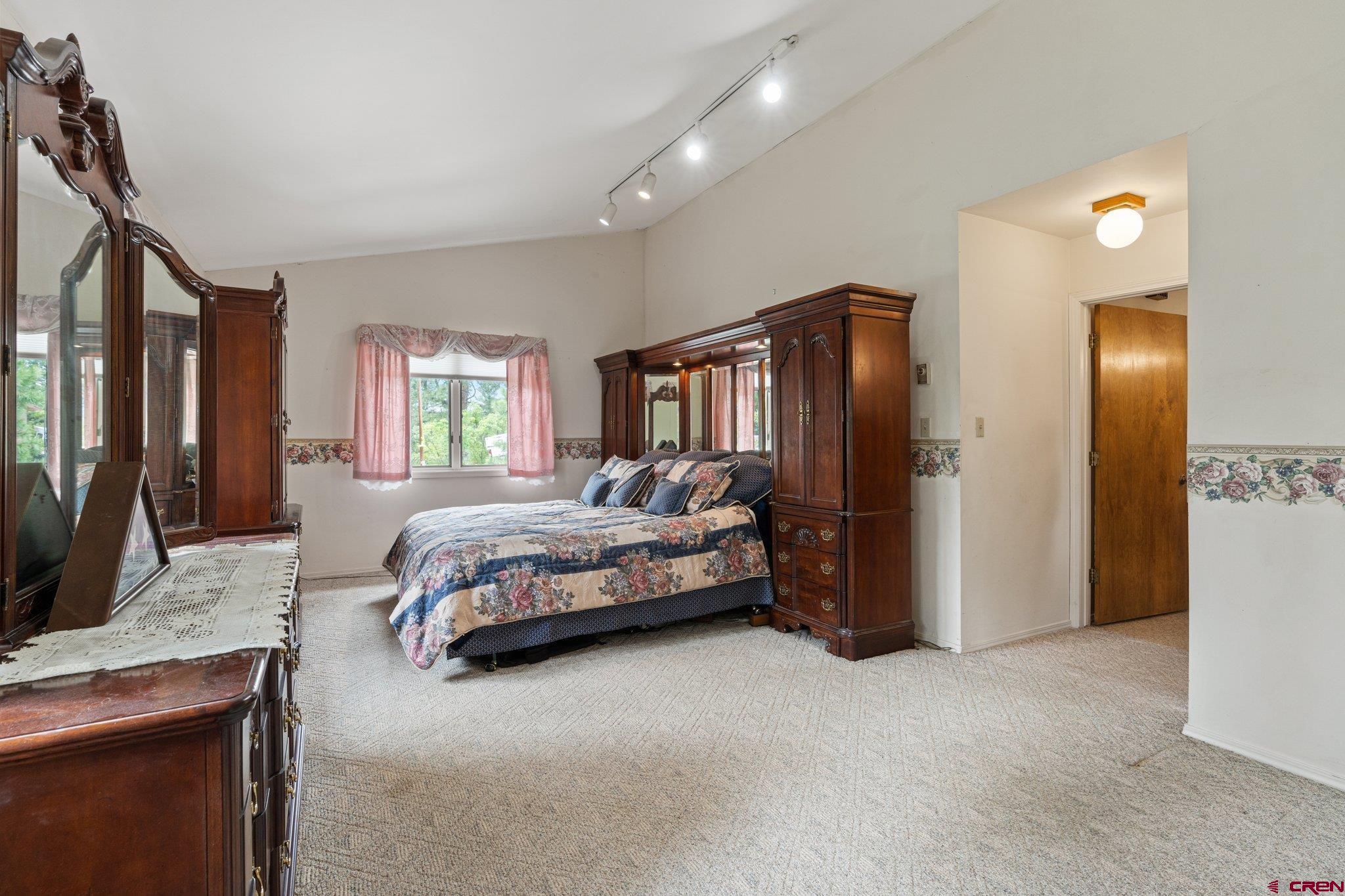 67 Pine Ridge Loop Durango, CO 81301 - Photo 15 of 35 a spacious bedroom with a large bed and a dresser