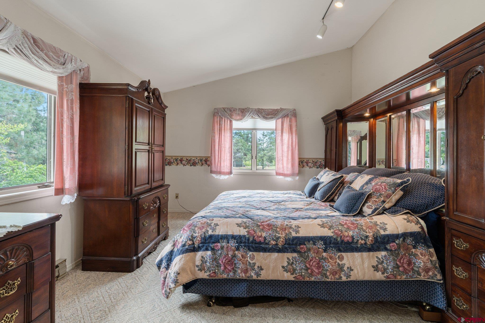 67 Pine Ridge Loop Durango, CO 81301 - Photo 16 of 35 a bedroom with a bed a dresser and a window