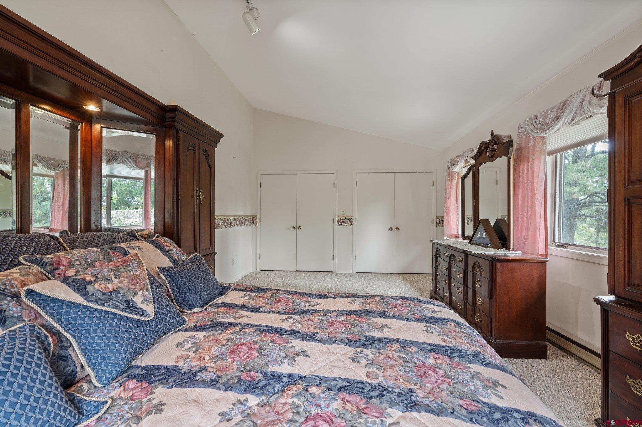 67 Pine Ridge Loop Durango, CO 81301 - Photo 17 of 35 a bedroom with a large bed and windows
