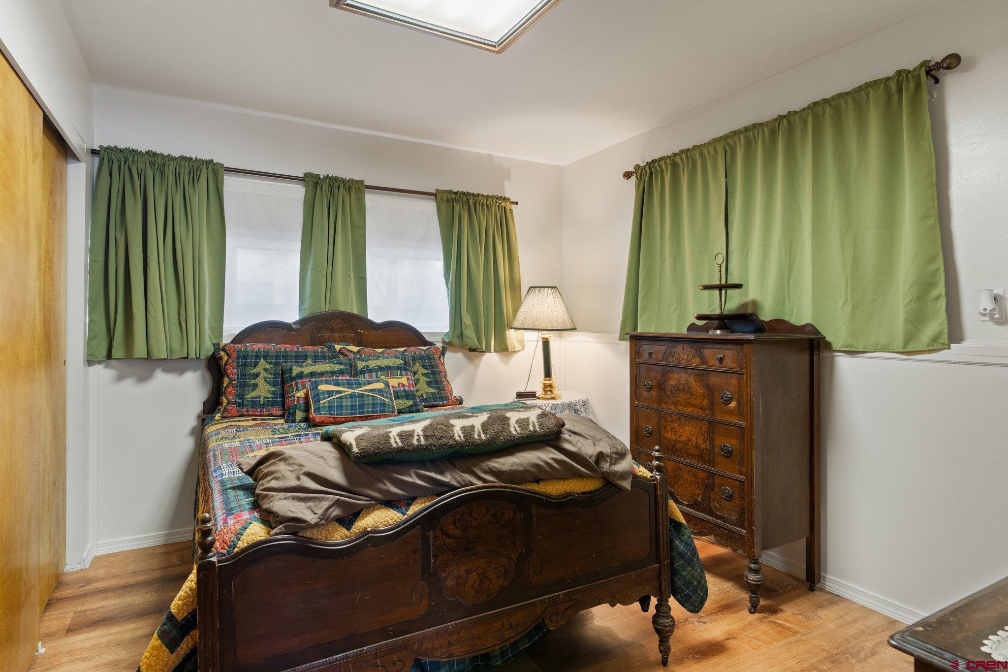 67 Pine Ridge Loop Durango, CO 81301 - Photo 21 of 35 a bedroom with a bed and green walls