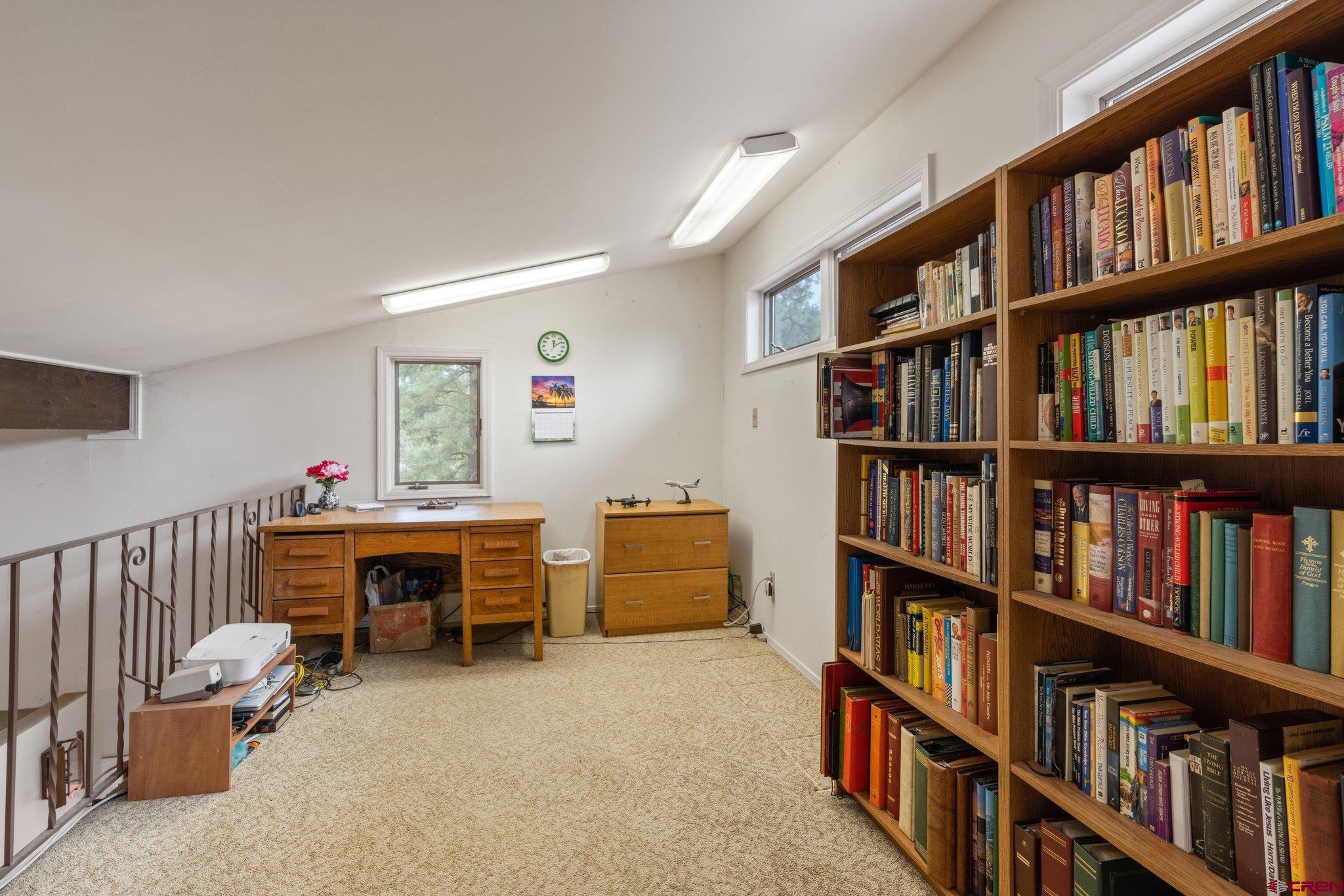 67 Pine Ridge Loop Durango, CO 81301 - Photo 22 of 35 a living room with furniture and a book shelf