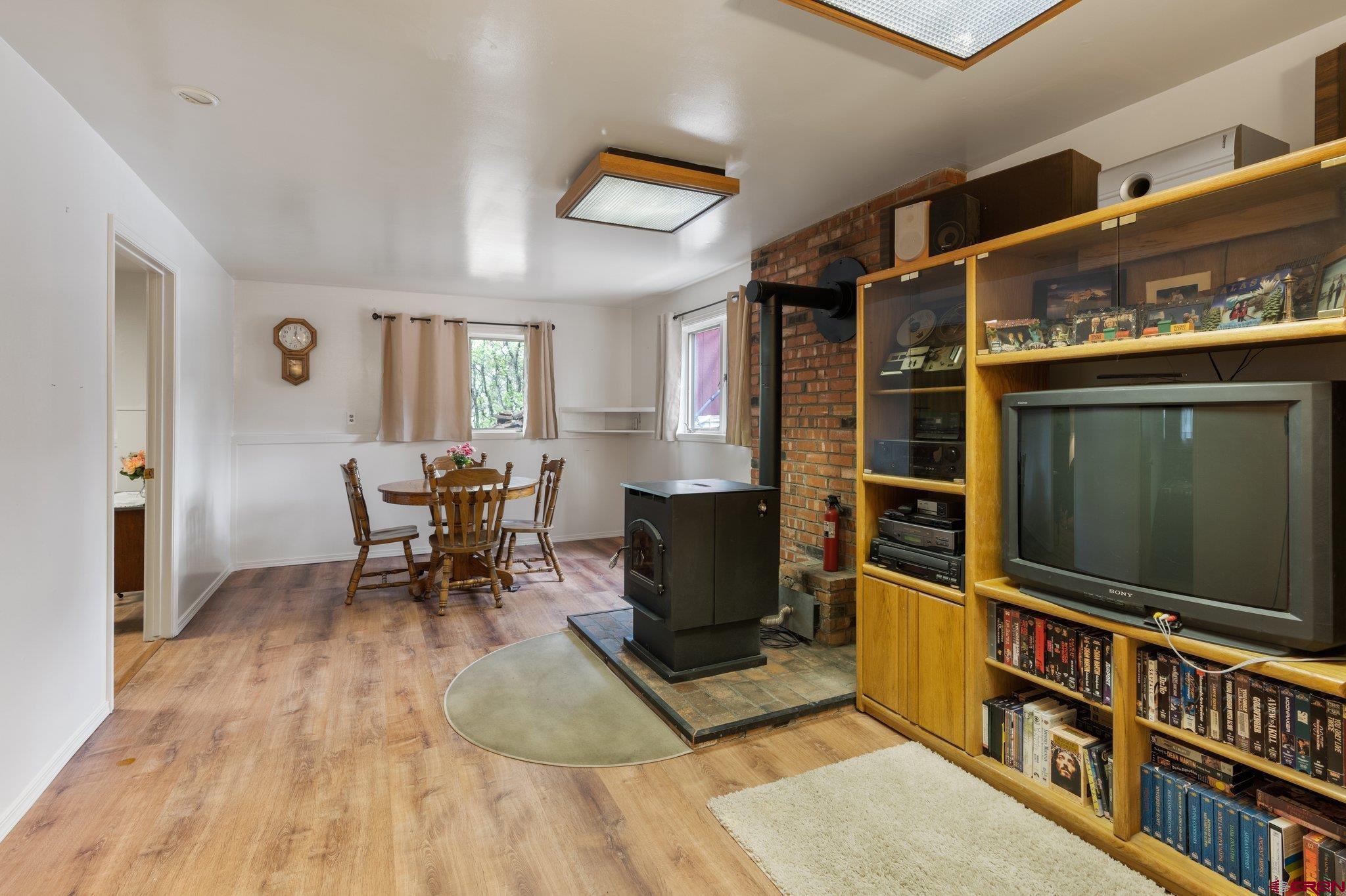67 Pine Ridge Loop Durango, CO 81301 - Photo 28 of 35 a living room with furniture a flat screen tv and paintings on the wall