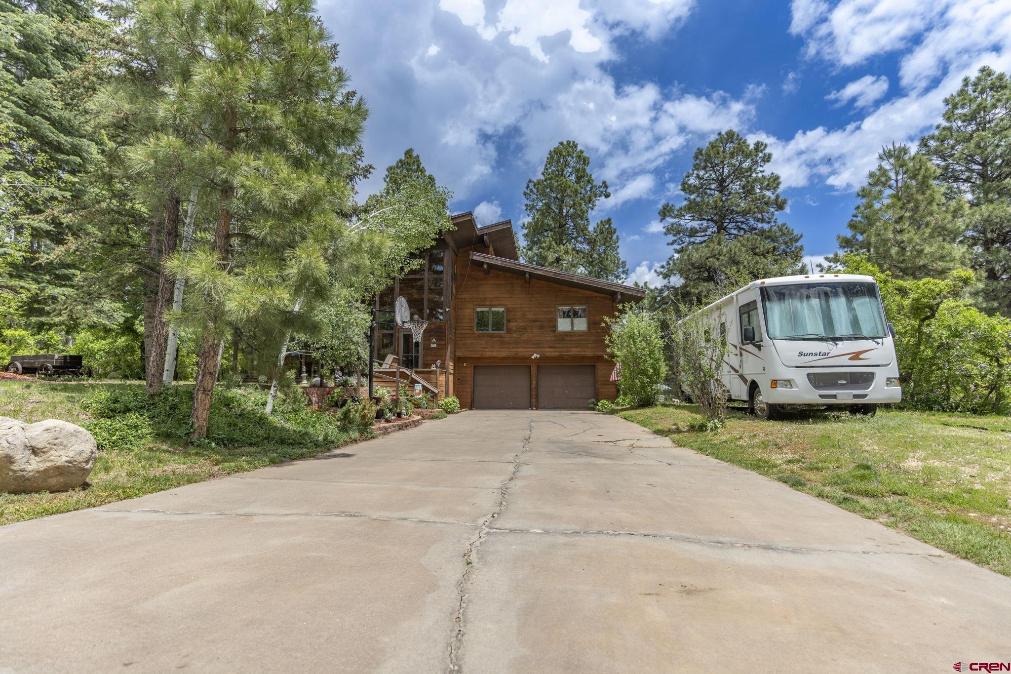67 Pine Ridge Loop Durango, CO 81301 - Photo 3 of 35 a front view of a house with garden