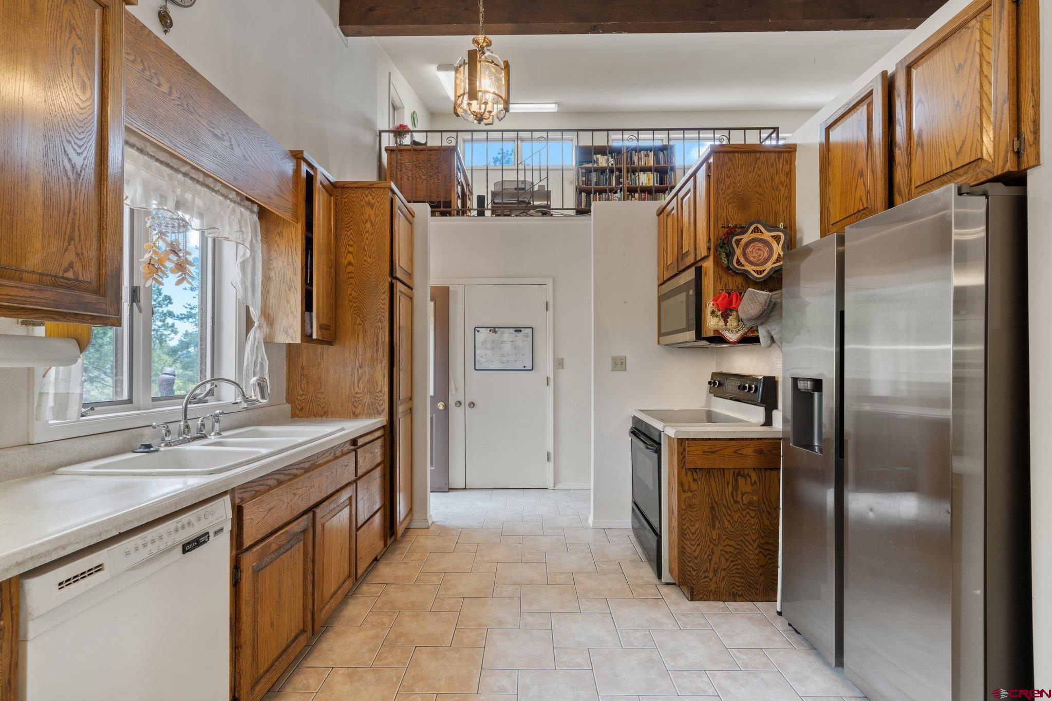 67 Pine Ridge Loop Durango, CO 81301 - Photo 7 of 35 a kitchen with stainless steel appliances granite countertop a refrigerator and a sink