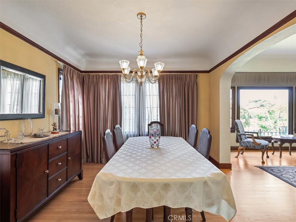 945 Rosemount Road Glendale, CA 91207 - Photo 17 of 31 a spacious bedroom with a bed and a chandelier