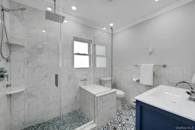 a bathroom with a sink mirror and a shower