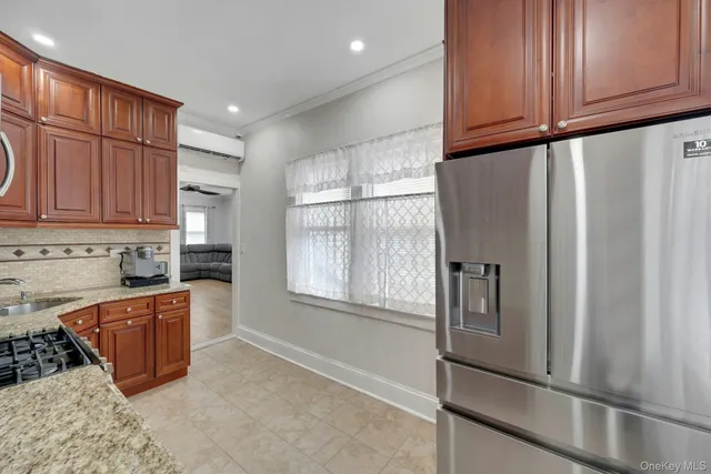 a kitchen with stainless steel appliances granite countertop a refrigerator sink and cabinets