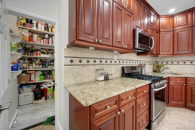 a kitchen with stainless steel appliances granite countertop a stove and a microwave