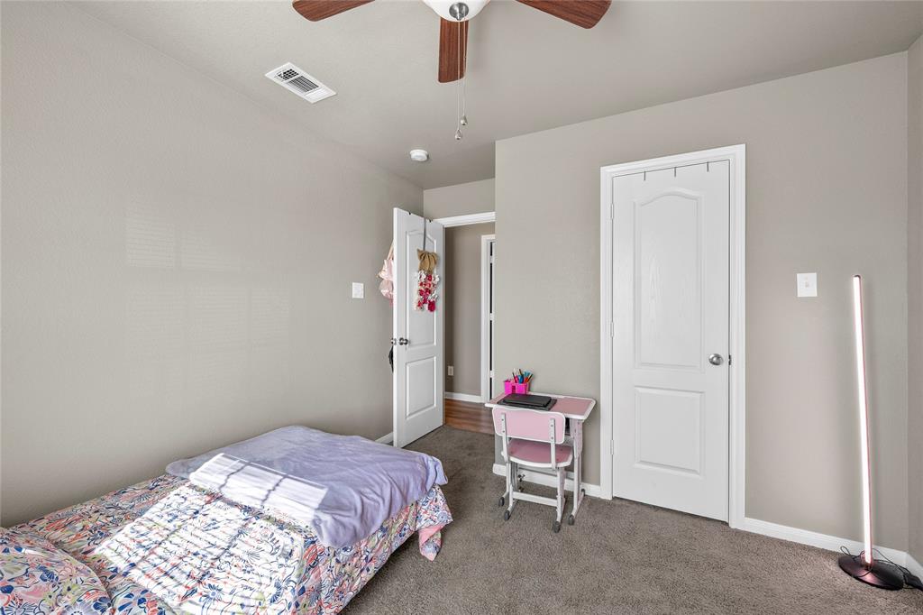 606 Powers Street Lacy-Lakeview, TX 76705 - Photo 18 of 23 a bedroom with a bed and a chandelier