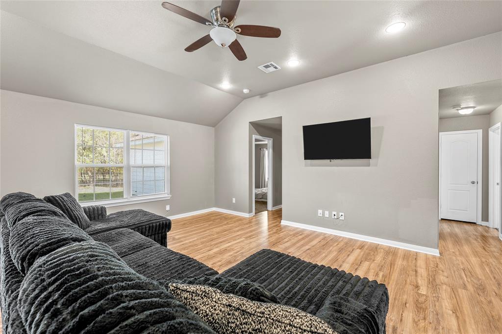 606 Powers Street Lacy-Lakeview, TX 76705 - Photo 5 of 23 a bedroom with a large bed and a flat screen tv