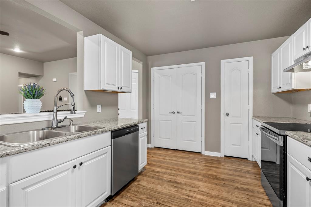 606 Powers Street Lacy-Lakeview, TX 76705 - Photo 7 of 23 a kitchen with granite countertop a sink and cabinets