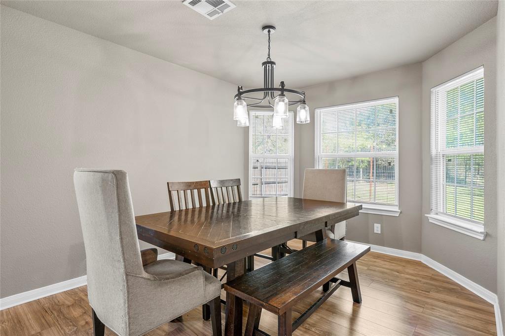 606 Powers Street Lacy-Lakeview, TX 76705 - Photo 10 of 23 a view of a dining room with furniture window and wooden floor