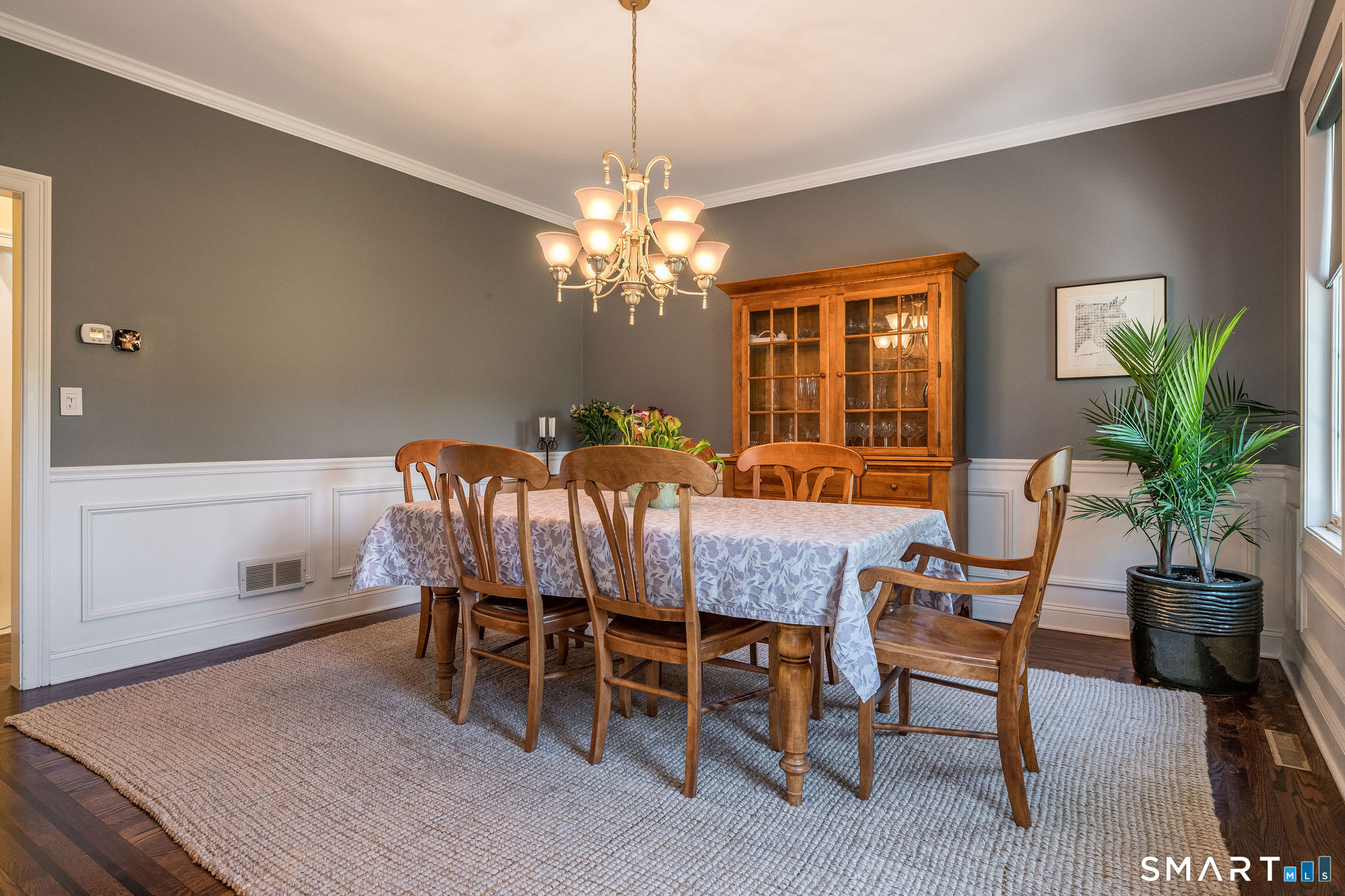 170 Devonshire Lane Madison, CT 06443 - Photo 15 of 39 a dining room with furniture potted plants and wooden floor