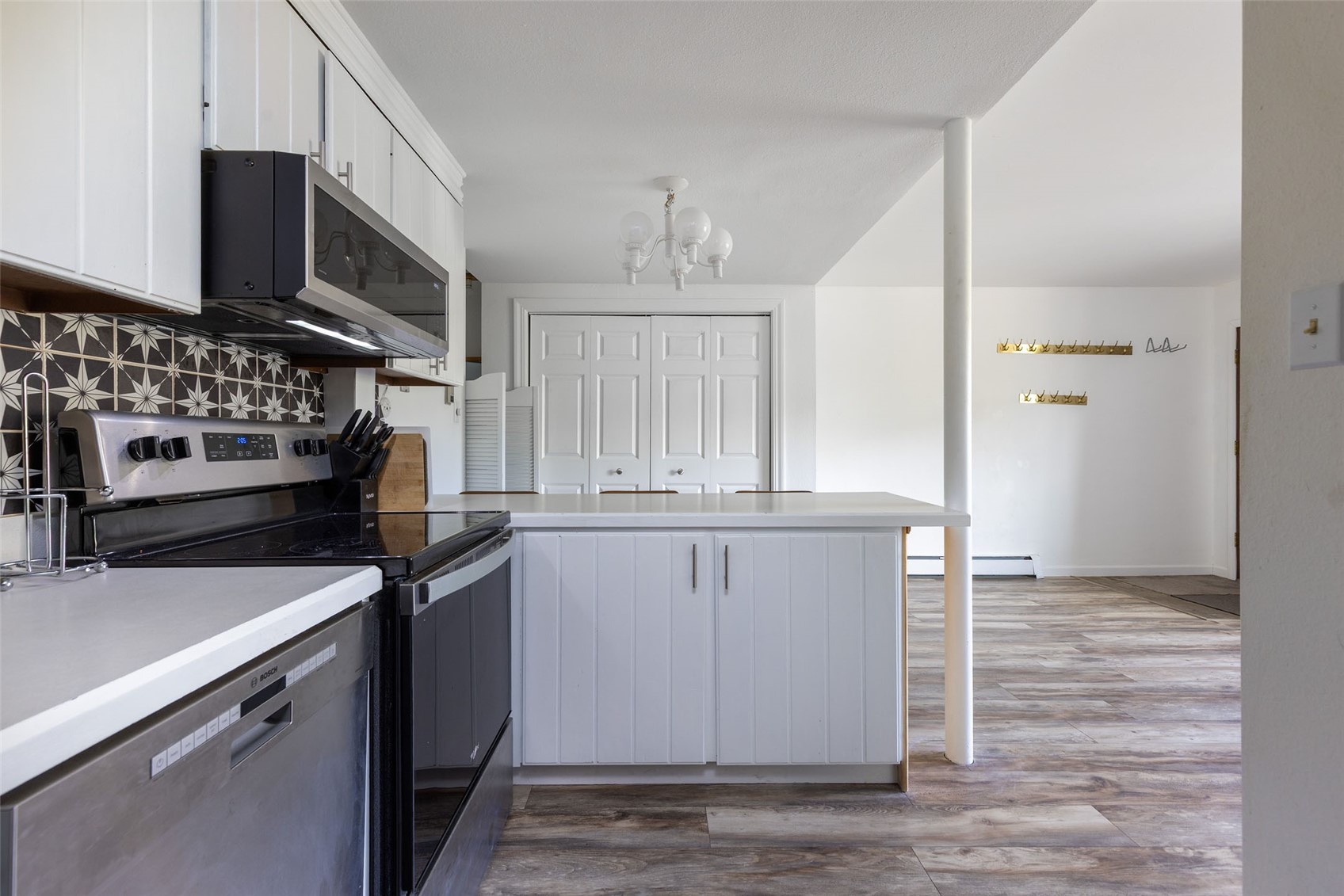 180 Evergreen Road, Unit 105 Dillon, CO 80435 - Photo 11 of 24 a kitchen with granite countertop white cabinets and stainless steel appliances