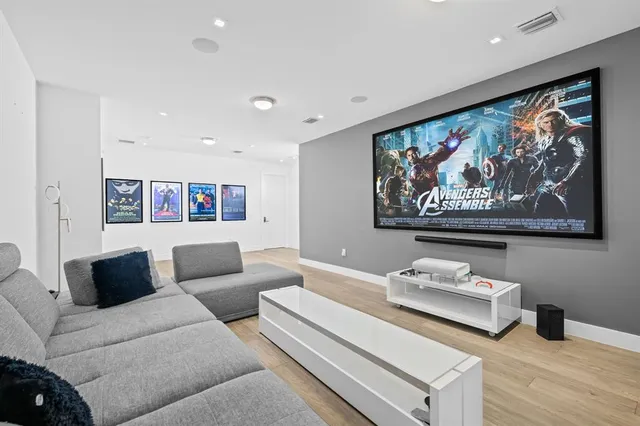 a living room with furniture and wall paintings