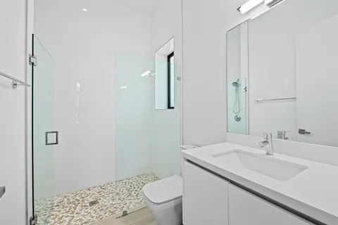 a bathroom with a sink toilet and shower