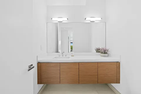 a bathroom with a sink vanity and mirror