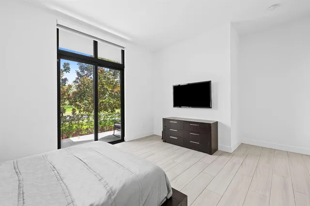 a bedroom with a bed and a flat screen tv