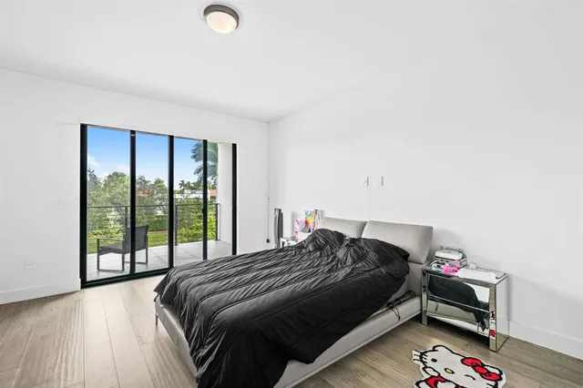 a bedroom with a bed and a large window