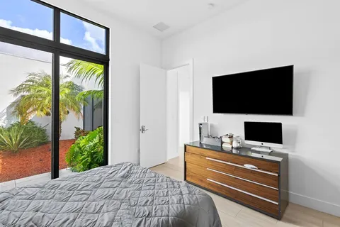 a bedroom with a bed and a flat screen tv