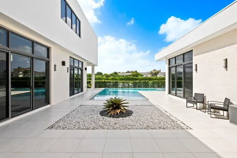 a view of a house with backyard and porch