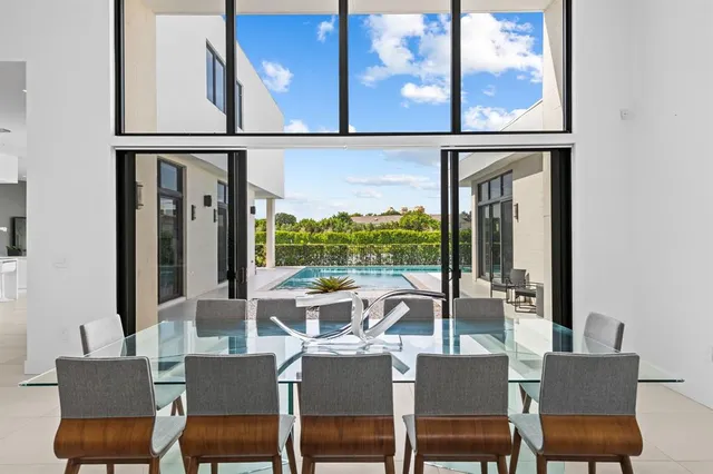 an outdoor view from a dining room with a large window