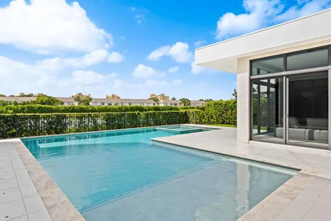 a view of a swimming pool with a lawn chairs
