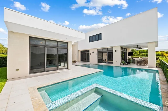 a view of a backyard with a swimming pool