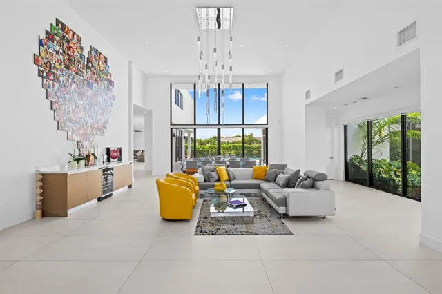 a living room with fireplace furniture and a chandelier