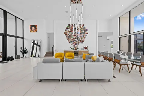 a living room with furniture a chandelier and a chandelier