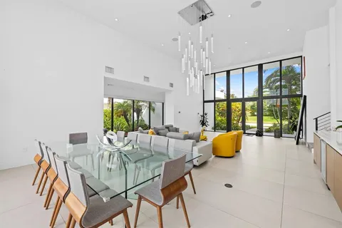a dining room with furniture and a large window