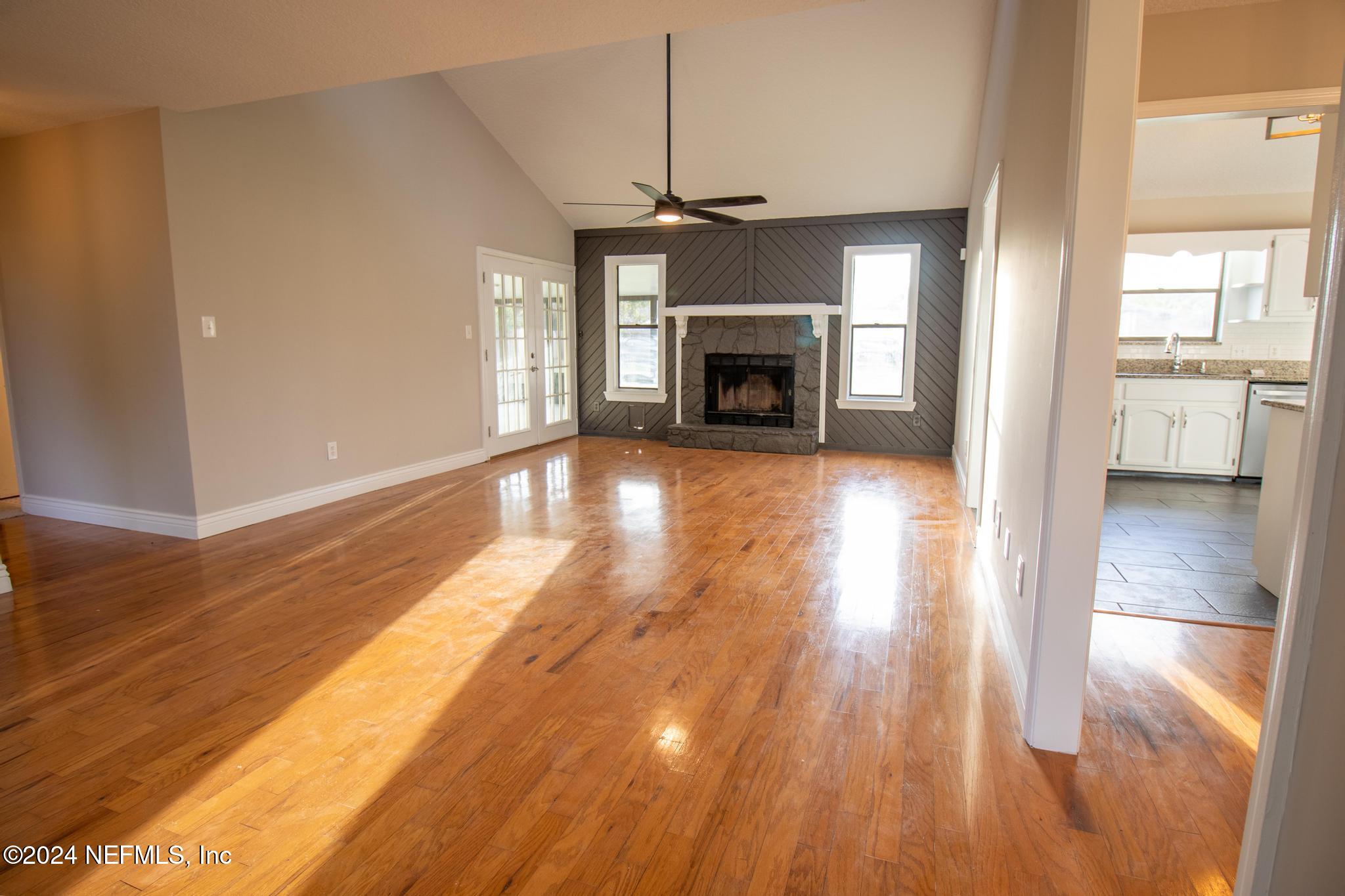 157 Timber Lane Crossing Palatka, FL 32177 - Photo 3 of 16 a view of empty room with wooden floor and fireplace