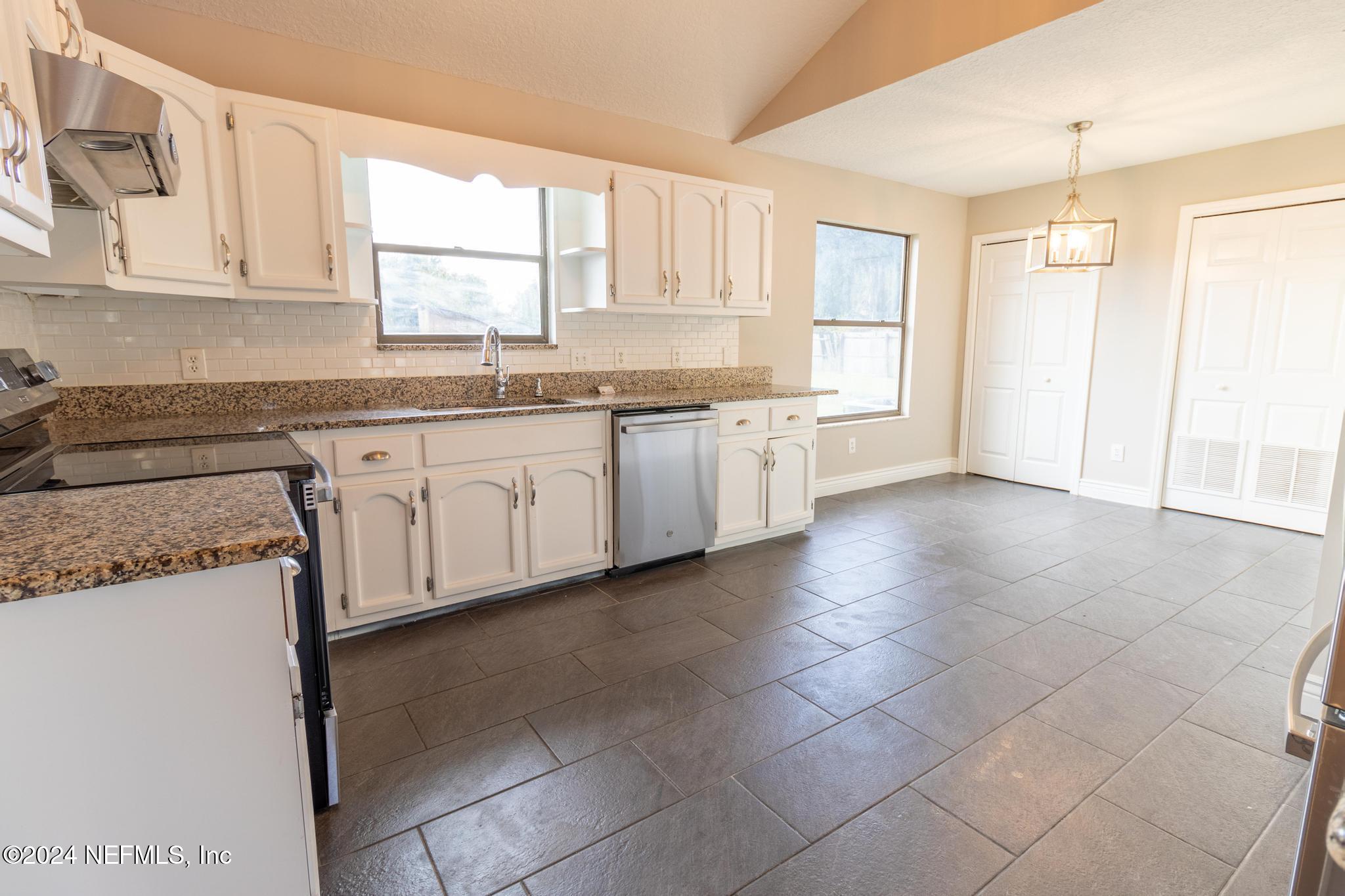 157 Timber Lane Crossing Palatka, FL 32177 - Photo 4 of 16 a kitchen with a sink window and cabinets