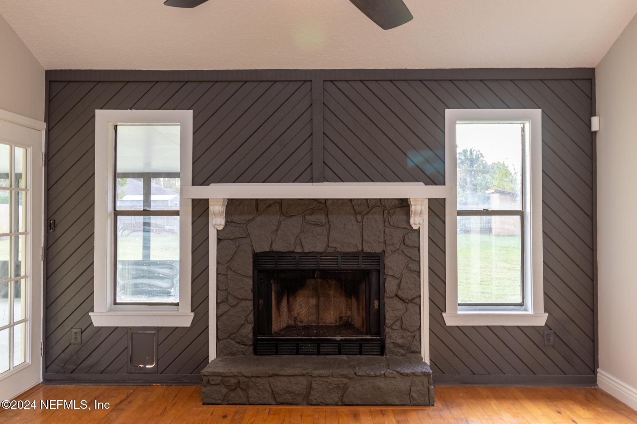 157 Timber Lane Crossing Palatka, FL 32177 - Photo 5 of 16 a living room with a fireplace windows and a fireplace