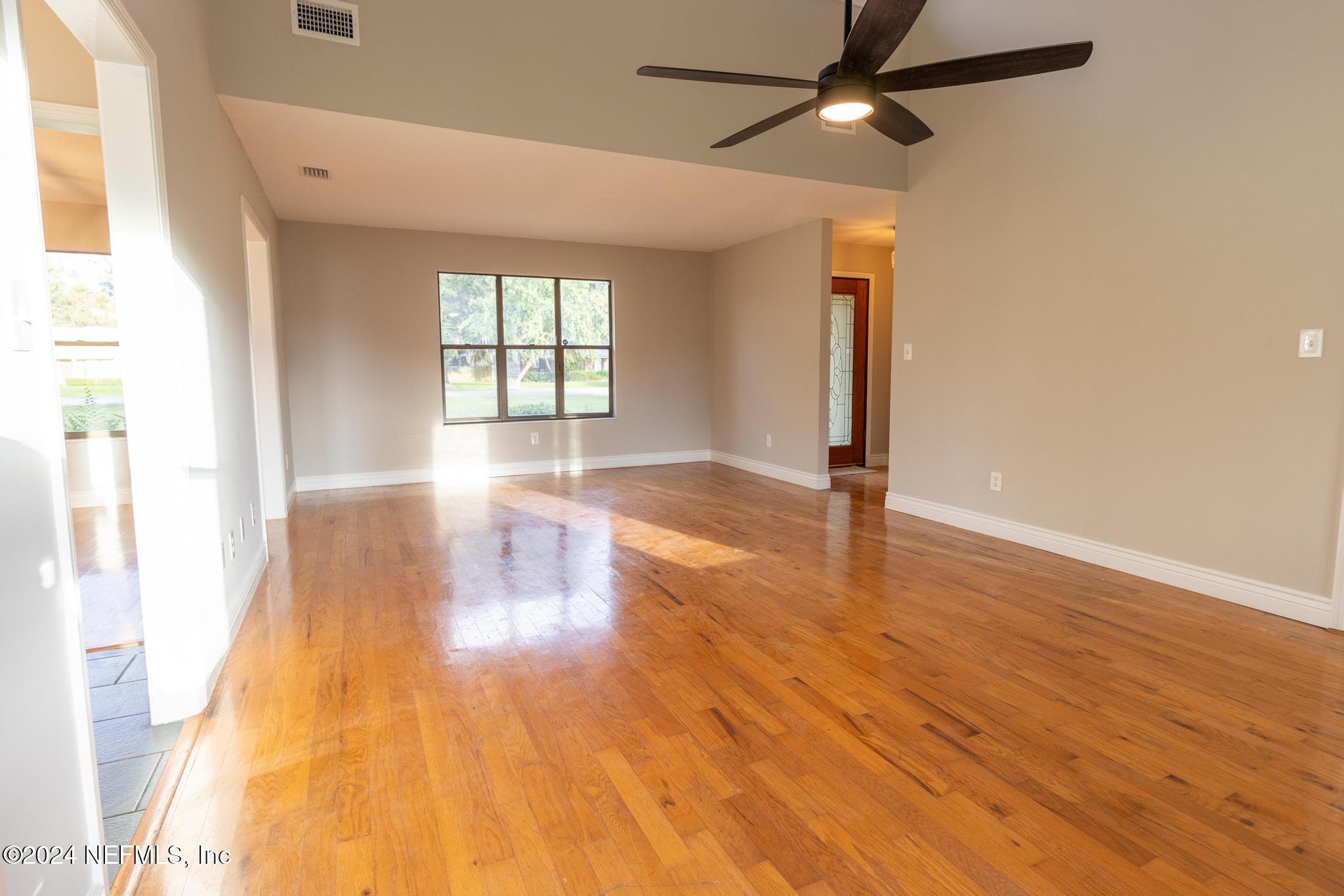 157 Timber Lane Crossing Palatka, FL 32177 - Photo 7 of 16 a view of empty room with wooden floor and fan