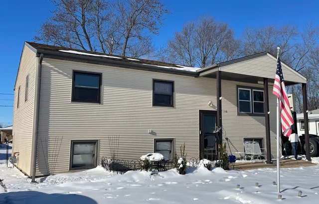 a kitchen with stainless steel appliances granite countertop a refrigerator stove and sink