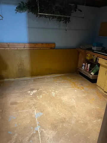 a kitchen with a refrigerator wooden floor and a window