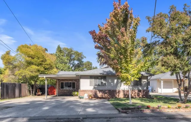 a view of a house with a tree and yard