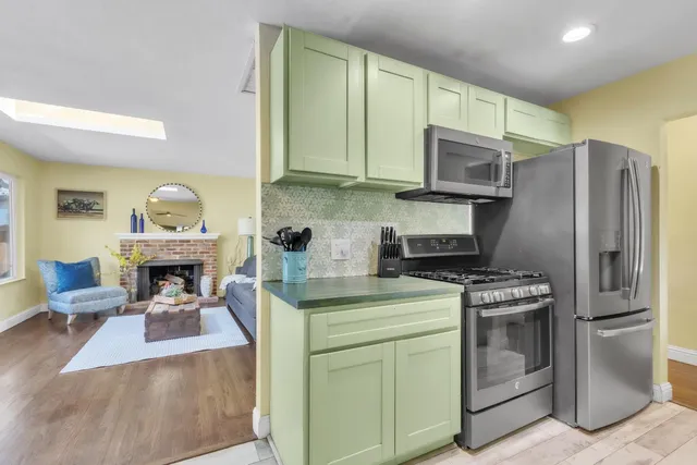 a kitchen with stainless steel appliances granite countertop a stove and a refrigerator