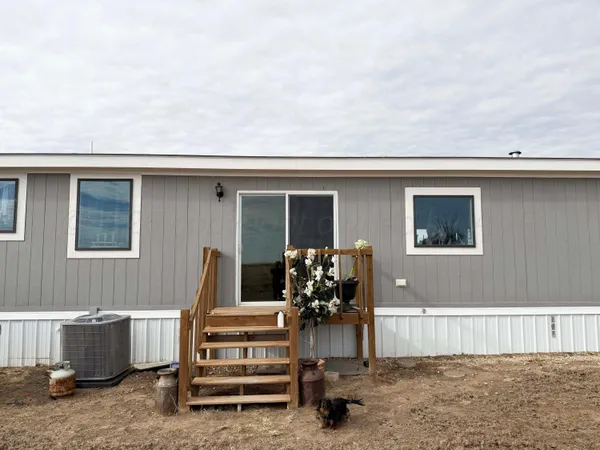 a house with a yard and wooden fence