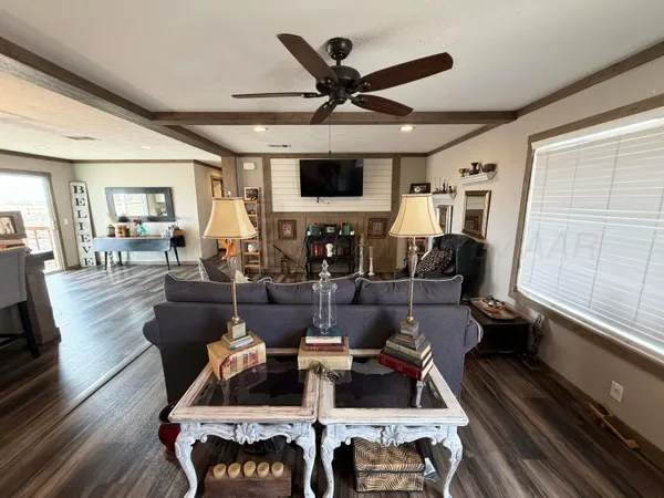 a living room with furniture window and wooden floor