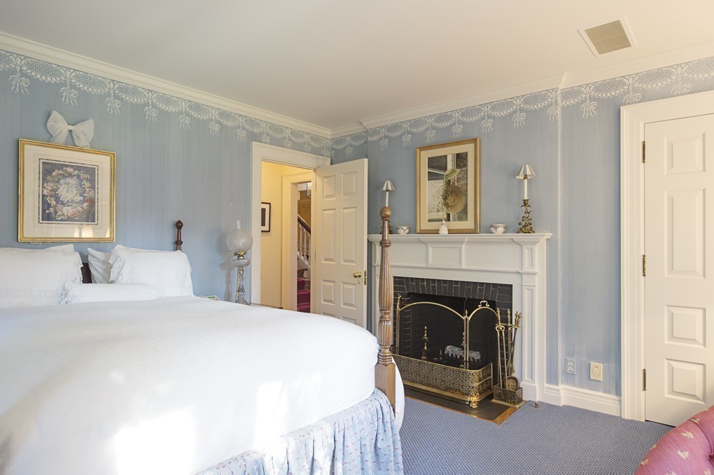 2 Laxfield Road Weston, MA 02493 - Photo 26 of 30 a bedroom with a bed and a fireplace